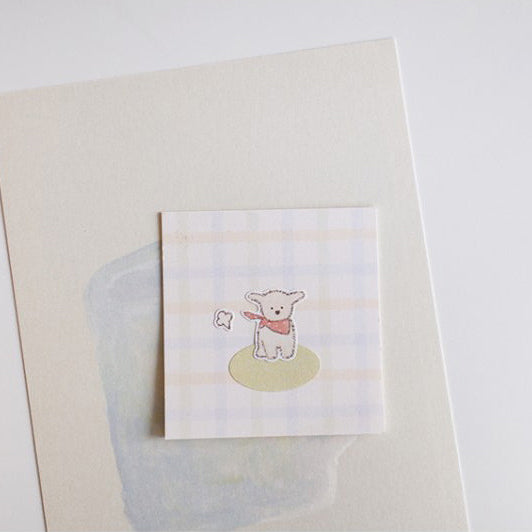 Small card with a bear illustration on a textured surface