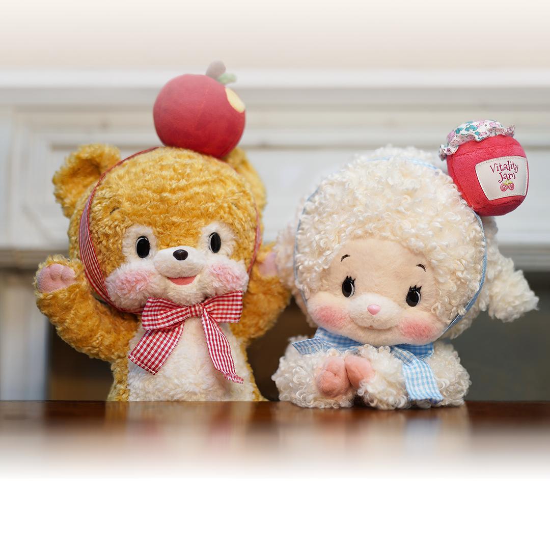 Two plush toys and a book titled 'Breakfast Club' on a wooden surface.