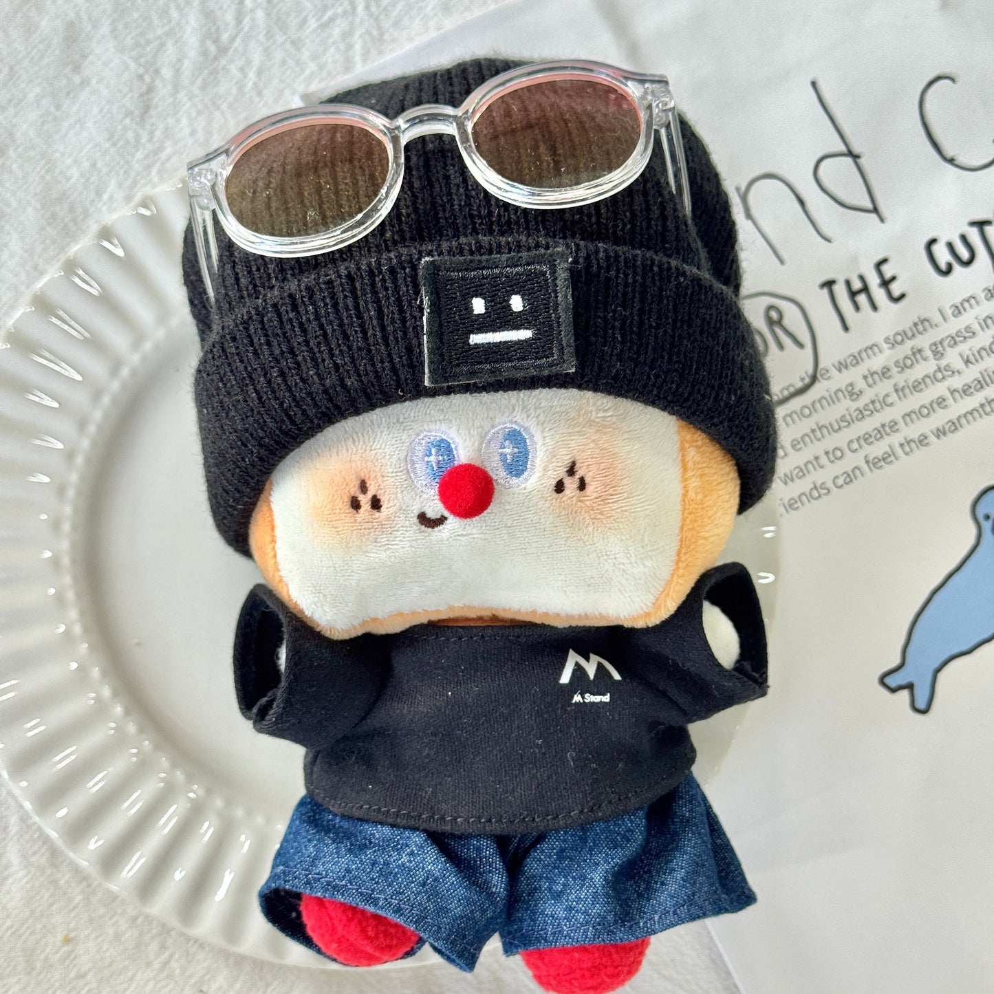 Toy figure of a character with a black helmet and sunglasses on a white plate