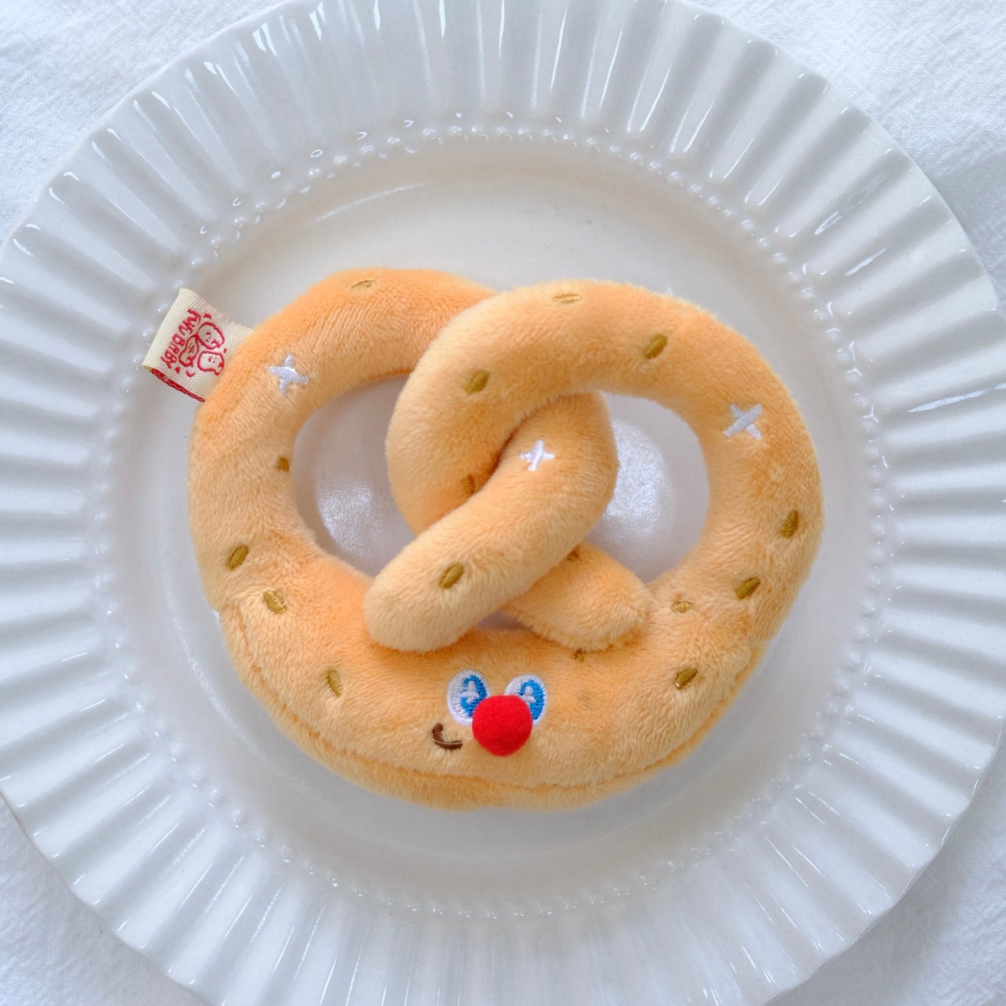 Toy snake with a face on a white plate