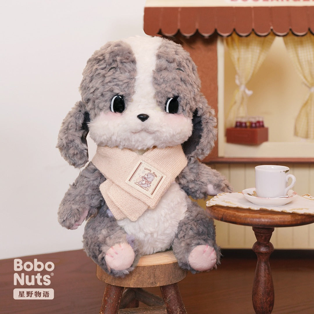 Plush toy dog with a scarf sitting on a stool in front of a bakery-themed background
