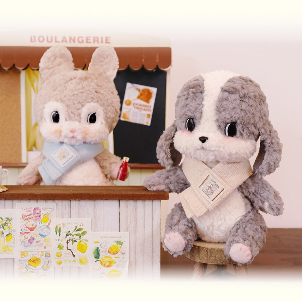 Two plush toys named Luna and Gogo in front of a bakery-themed background.